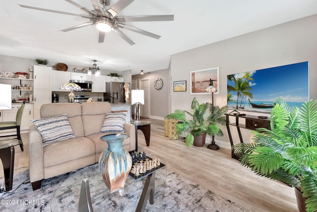 living room with ceiling fan and light hardwood / wood-style floors