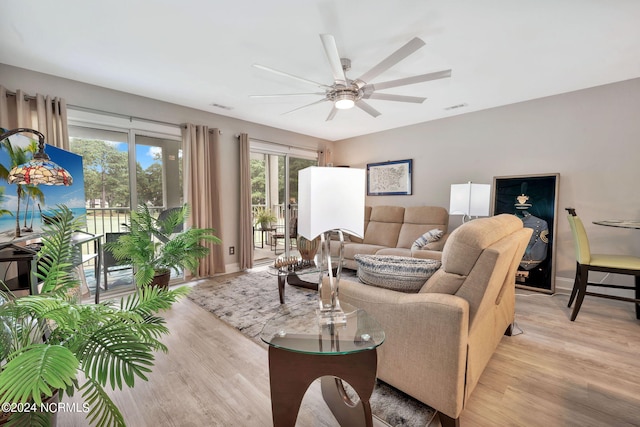 living room with light hardwood / wood-style floors and ceiling fan