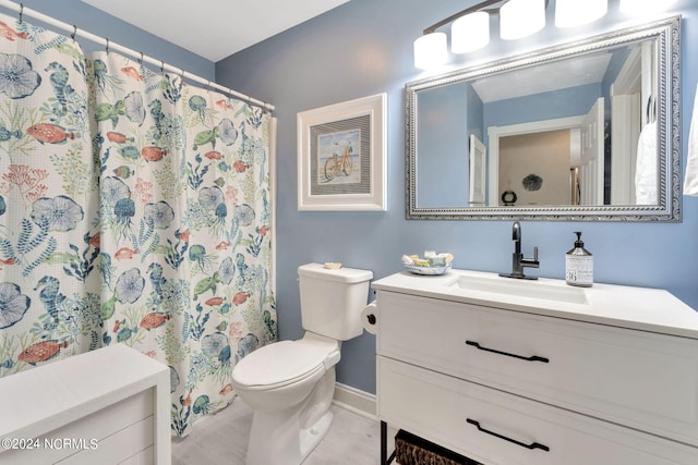 bathroom featuring vanity, toilet, and a shower with shower curtain