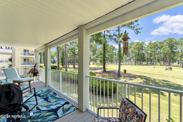 wooden terrace with a lawn