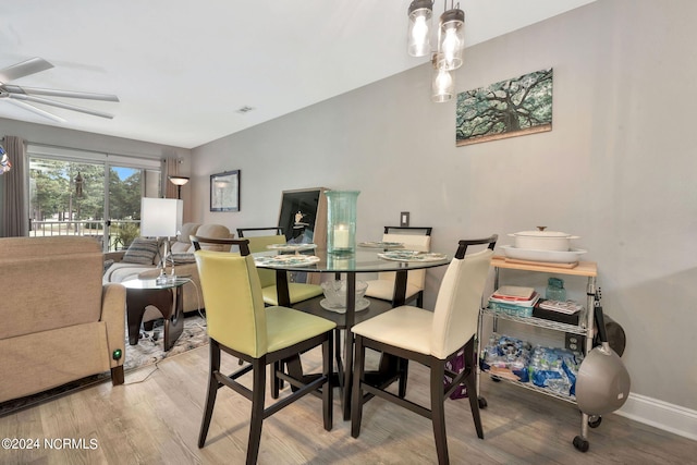 dining area with wood-type flooring and ceiling fan