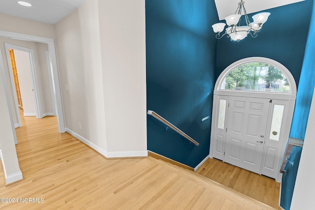 foyer entrance with a notable chandelier and wood-type flooring