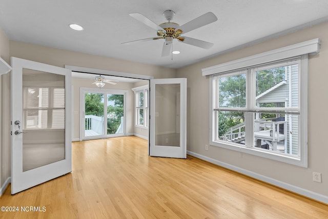 interior space with ceiling fan, light hardwood / wood-style floors, and french doors