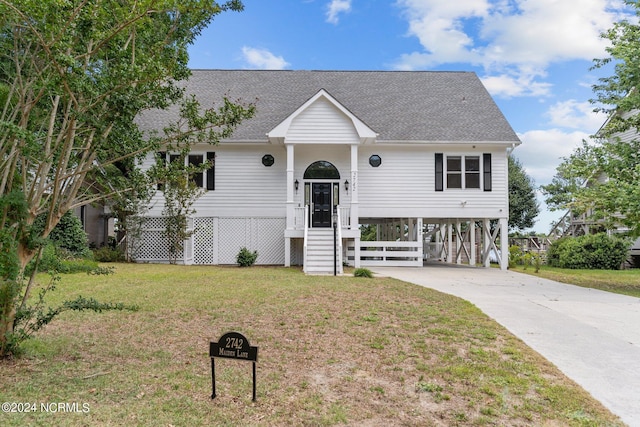 split foyer home with a front yard and a carport