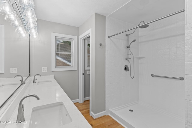 bathroom with vanity, a shower, and wood-type flooring