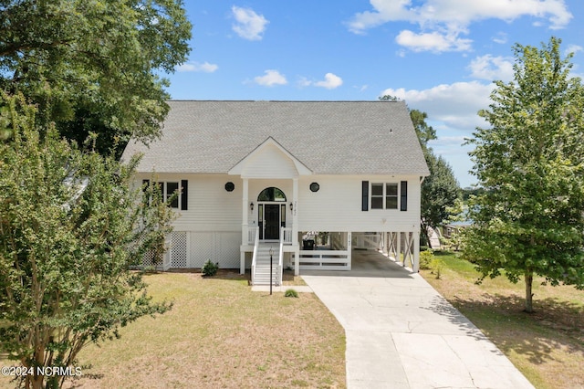 view of front of property with a front lawn and a carport