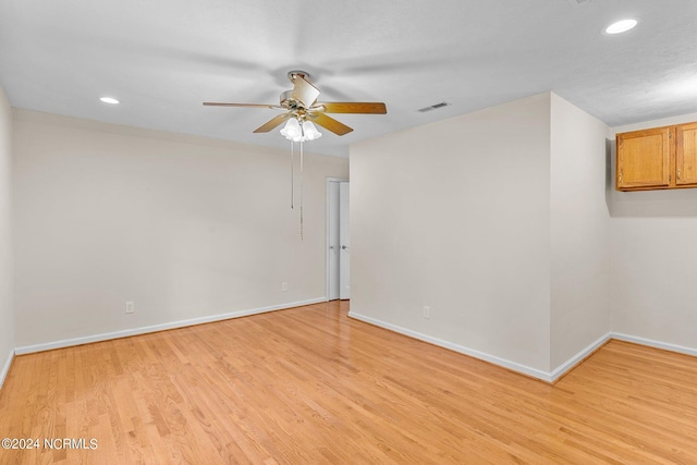 empty room featuring light hardwood / wood-style flooring and ceiling fan