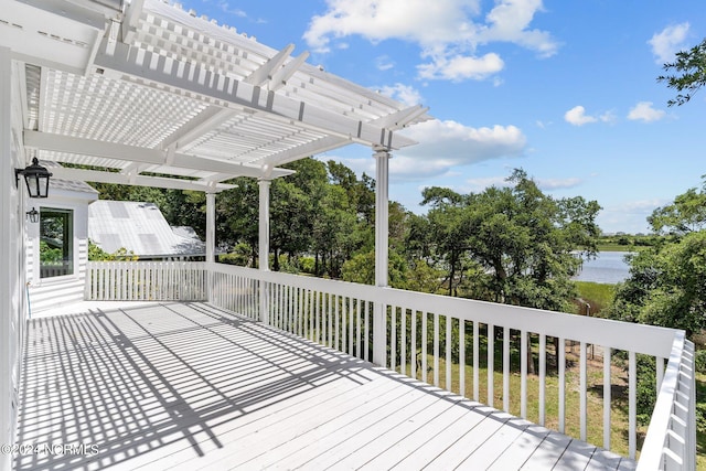 deck with a water view and a pergola