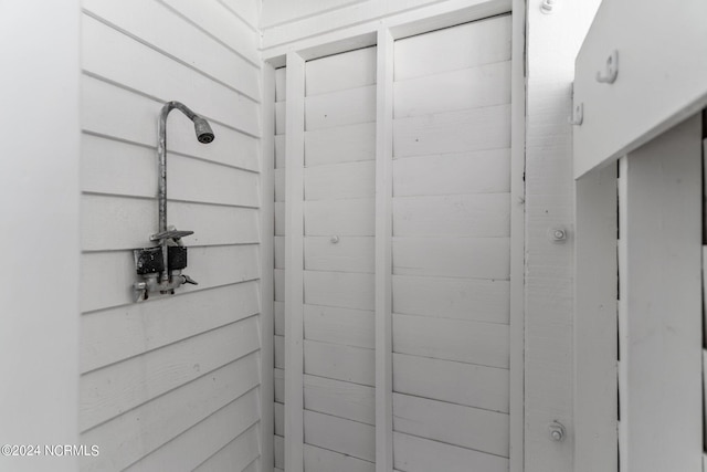 bathroom featuring wooden walls