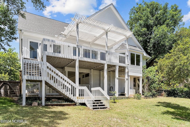 rear view of property with a pergola, a lawn, and a deck