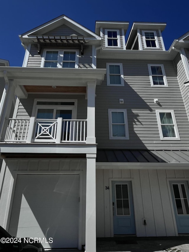 200 Olde Towne Yacht Club Dr Unit 34, Beaufort, NC 28516 - townhome / multi-family property featuring a balcony, a standing seam roof, metal roof, board and batten siding, and a garage