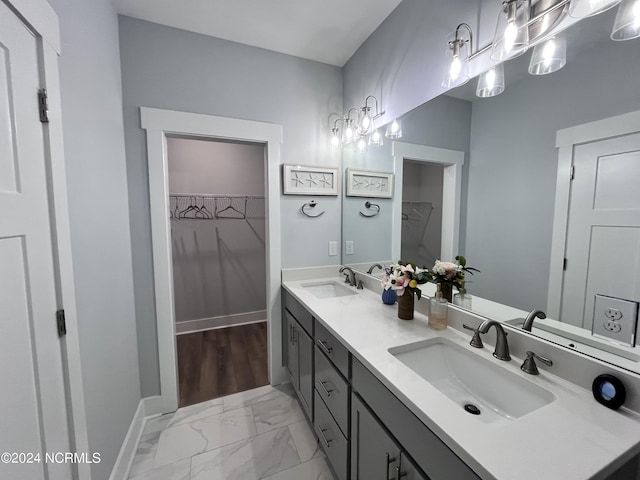 200 Olde Towne Yacht Club Dr Unit 34, Beaufort, NC 28516 - bathroom with double vanity, a spacious closet, marble look tiles, and baseboards