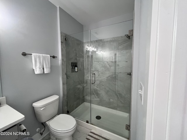 bathroom with walk in shower, vanity, and toilet