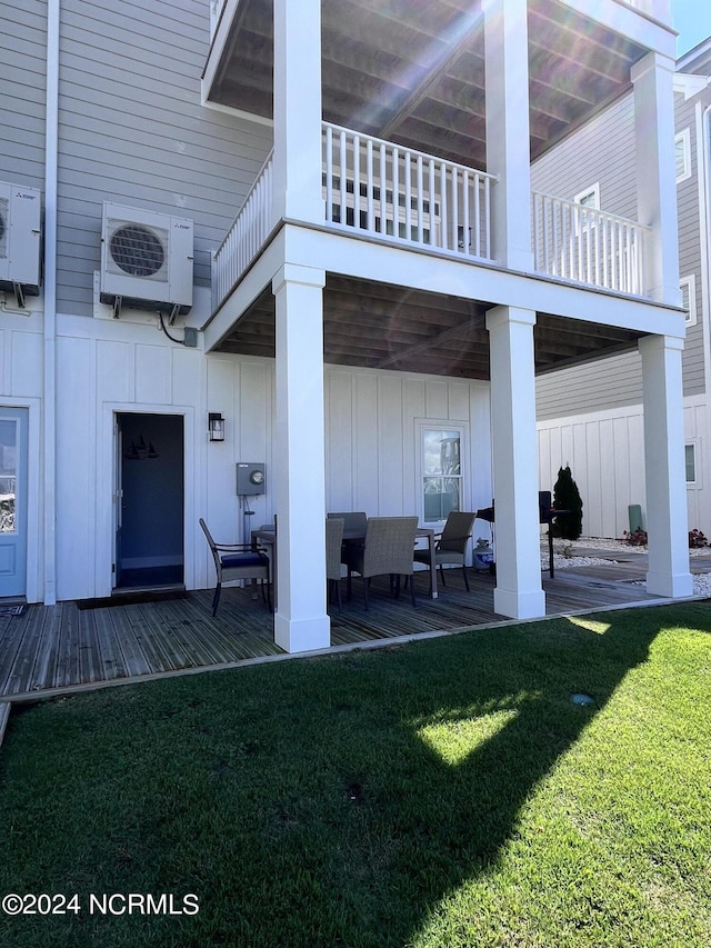 exterior space with outdoor lounge area, a balcony, ac unit, and a wooden deck