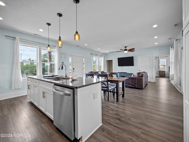 kitchen featuring sink, stainless steel dishwasher, a wealth of natural light, and an island with sink