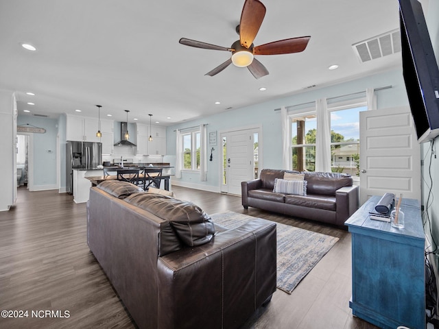 living room featuring hardwood / wood-style floors, a wealth of natural light, and ceiling fan