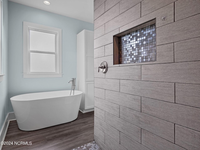 bathroom featuring a bathing tub and hardwood / wood-style floors