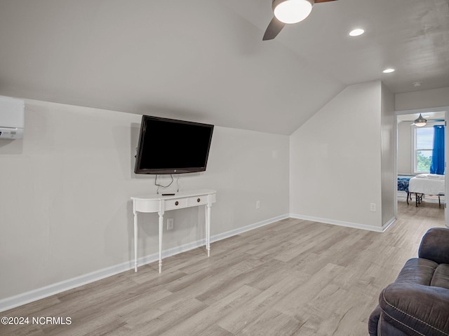 living room with vaulted ceiling, light hardwood / wood-style flooring, a wall mounted AC, and ceiling fan