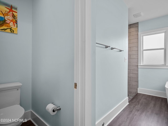 bathroom with hardwood / wood-style flooring and toilet