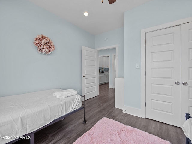 bedroom with dark hardwood / wood-style floors, a closet, and ceiling fan