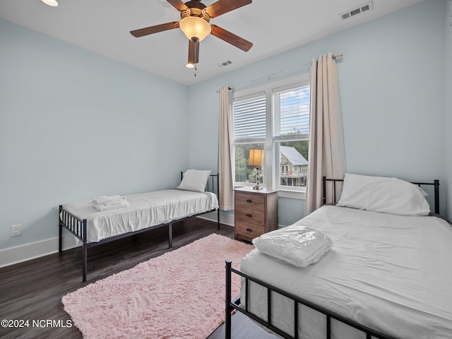 bedroom with ceiling fan and dark hardwood / wood-style floors