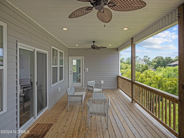 wooden terrace featuring ceiling fan