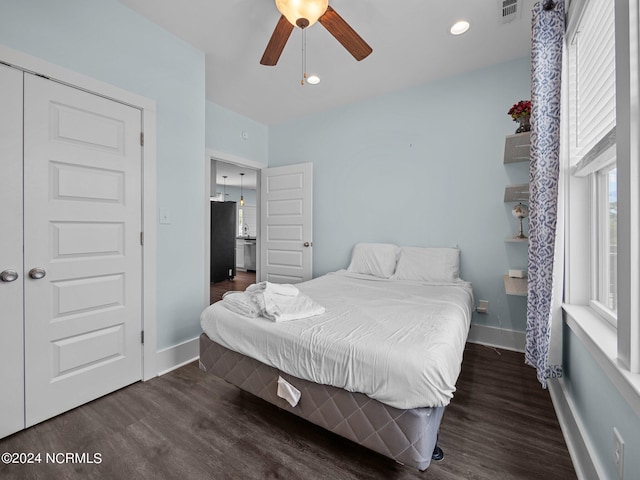 bedroom with a closet, ceiling fan, and dark wood-type flooring