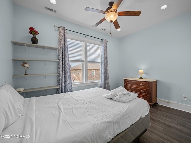 bedroom with dark hardwood / wood-style floors and ceiling fan