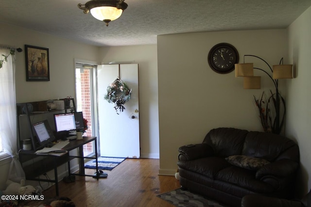 living room with hardwood / wood-style flooring and a textured ceiling