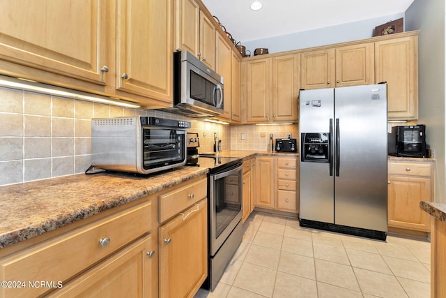 kitchen featuring decorative backsplash, light brown cabinets, light tile patterned floors, and stainless steel appliances