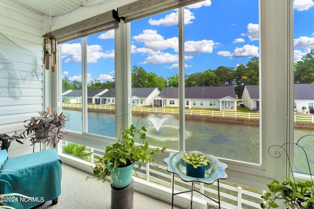 sunroom / solarium with a water view