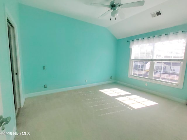 carpeted empty room featuring ceiling fan and vaulted ceiling