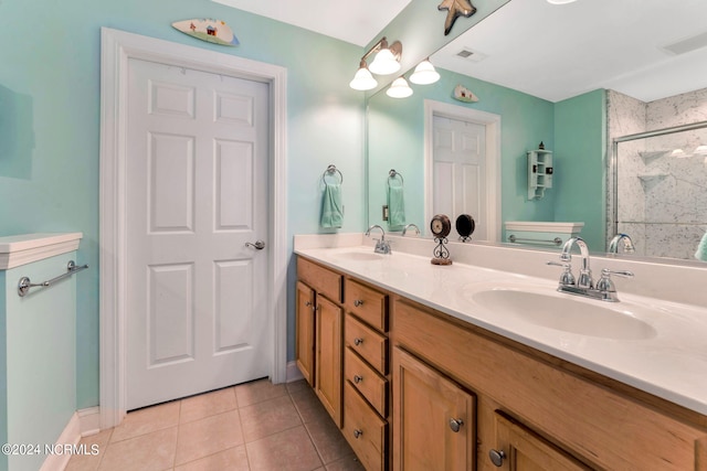 bathroom featuring tile patterned floors, vanity, and a shower with shower door