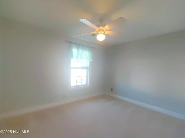 unfurnished room featuring carpet and ceiling fan