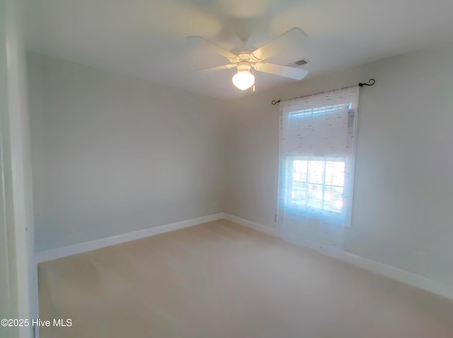 carpeted spare room with ceiling fan