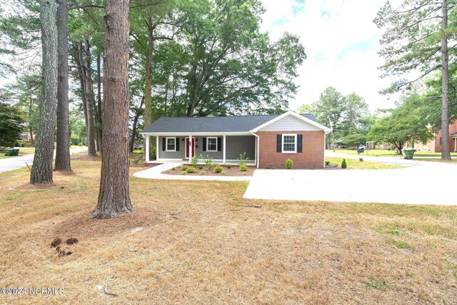 ranch-style house with a front yard and a porch