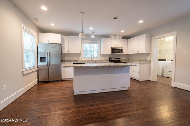 kitchen with dark hardwood / wood-style flooring, a kitchen island, stainless steel appliances, white cabinets, and pendant lighting