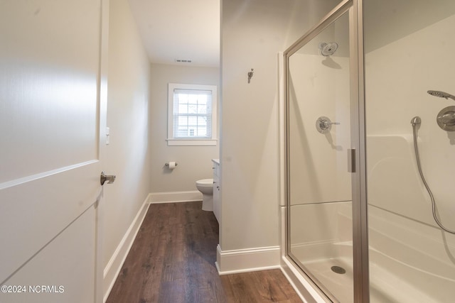 bathroom featuring an enclosed shower, vanity, hardwood / wood-style flooring, and toilet