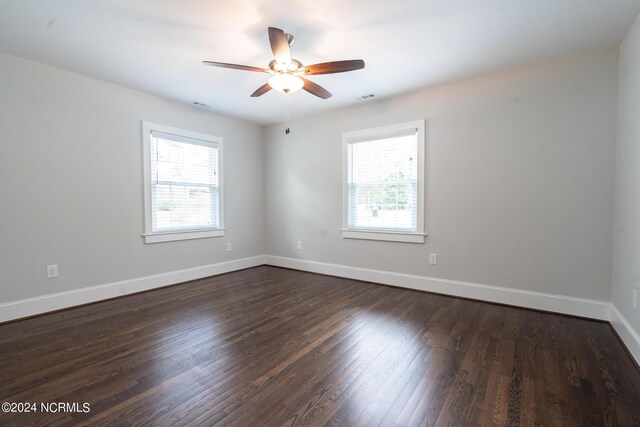 unfurnished room featuring a healthy amount of sunlight, hardwood / wood-style flooring, and ceiling fan