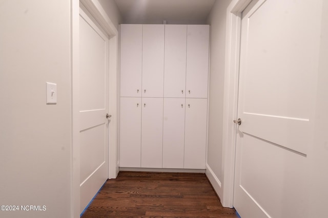 hallway with dark hardwood / wood-style flooring