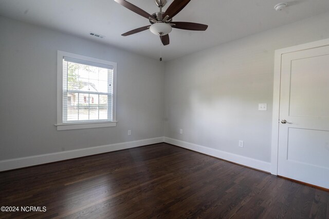 spare room with ceiling fan and dark hardwood / wood-style floors