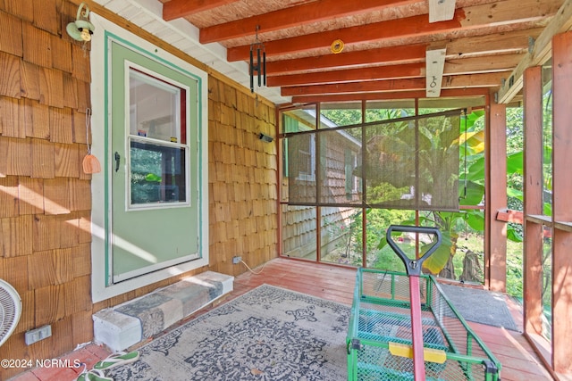 sunroom featuring beamed ceiling