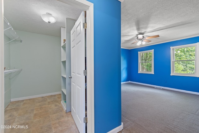 walk in closet with ceiling fan