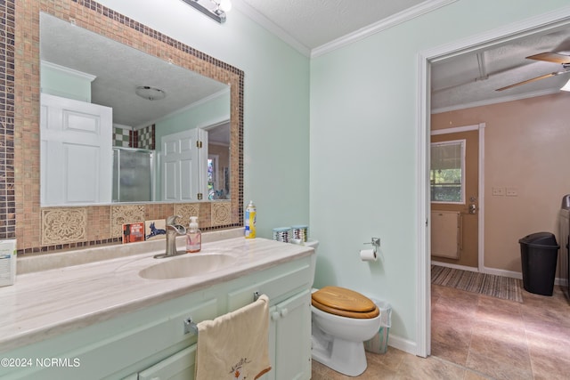 bathroom with backsplash, ornamental molding, an enclosed shower, toilet, and a textured ceiling