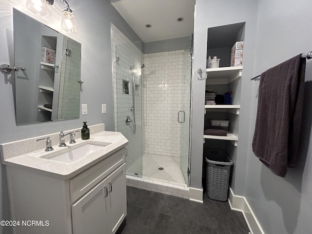 bathroom featuring hardwood / wood-style flooring, vanity, and an enclosed shower