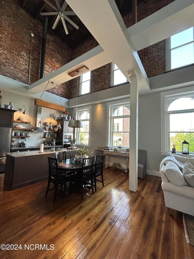 dining room featuring dark hardwood / wood-style flooring and a high ceiling