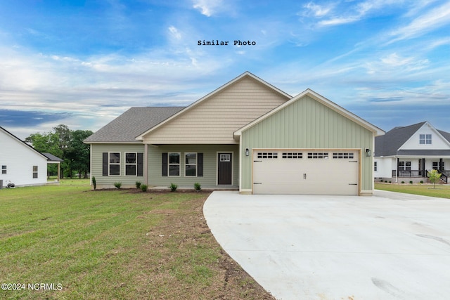 view of front of home with a front yard and a garage