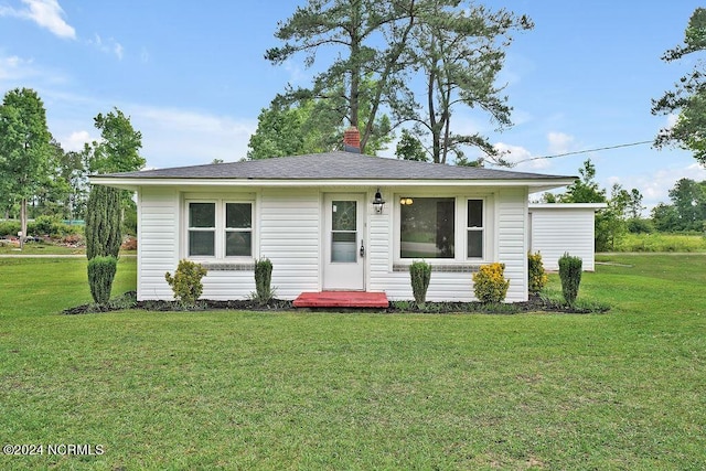 single story home with a front lawn and a chimney