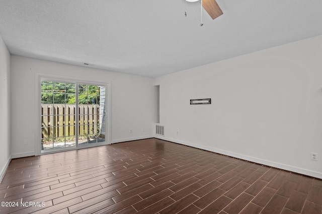 empty room with a textured ceiling and ceiling fan