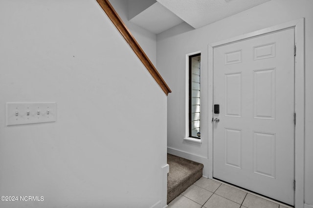 entryway featuring light tile patterned flooring